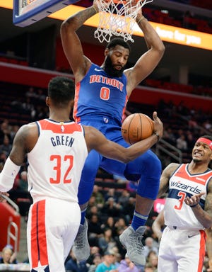 Pistons' Andre Drummond dunks over Wizards' Jeff Green in the second quarter.