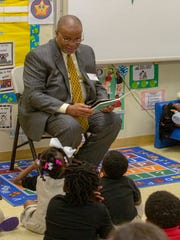 Sen. Gerald Boudreaux reads a book to a class of three-year-olds at the Gethsemane LaPetite Early Childhood Development Center following a summit on early childhood education. 