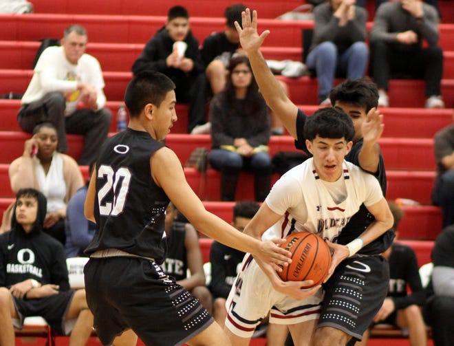 Junior Wildcat Robert Ornelas works his way out of a trap sprung by the Onate Knights' defense. Ornelas and the 'Cats suffered a 58-36 home loss Friday in District 3-5A play.
