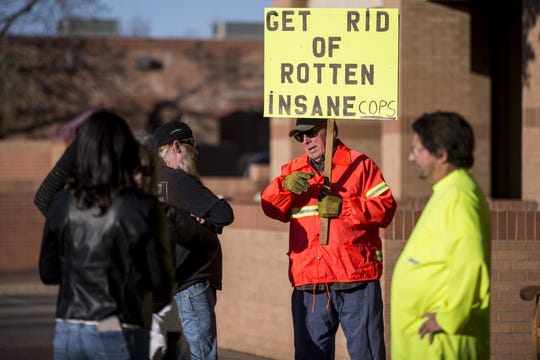 Bill Demski (right) and a man who asked to only be identified as J.D. talk during a small protest on Feb. 11, 2019, outside Glendale police headquarters. The police department has faced scrutiny after body cam footage was released of officers repeatedly using a Taser on a man in 2017, resulting in a federal lawsuit and one officer's suspension.