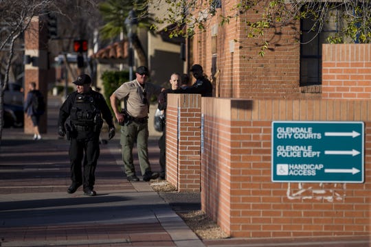 Glendale police officers stand outside headquarters on Feb. 11, 2019. The police department has faced scrutiny after body cam footage was released of officers repeatedly using a Taser on a man in 2017, resulting in a federal lawsuit and one officer's suspension.
