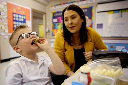 Kolton Wangler, 6, who has Type 1 diabetes, eats his lunch as his mom, Jessica Wangler, monitors his insulin dosage in his kindergarten classroom at St. Joseph Catholic School in Salem on Tuesday, Feb. 12, 2019. Wangler works in Sen. Peter Courtney's office, and when he heard her story he introduced a bill to allow people to get emergency insulin from the pharmacy.