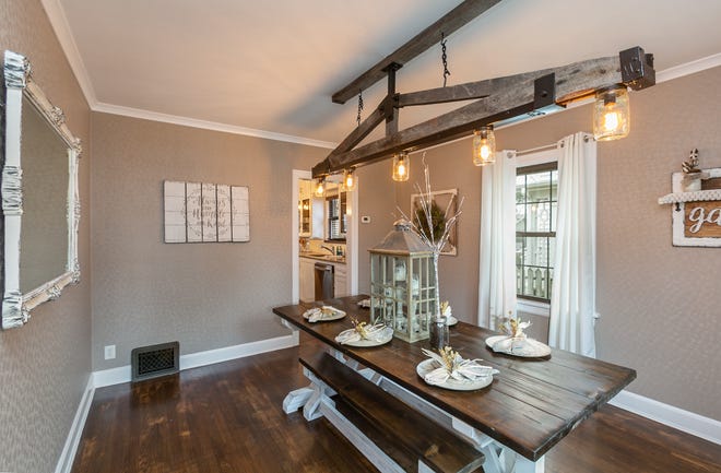 The light fixture Cindy designed from old trusses and a metal bed frame is the focal point in the dining room.