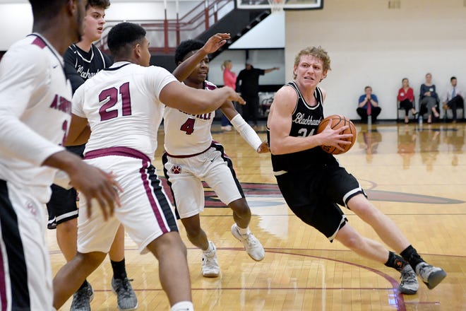 North Buncombe's Ren Dyer charges toward the basket against Asheville during their game at Asheville High School on Feb. 12, 2019. The Cougars defeated the Blackhawks 68-59 in overtime. 