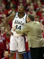 Nick Ward listens to Tom Izzo during the match against Wisconsin on Tuesday.