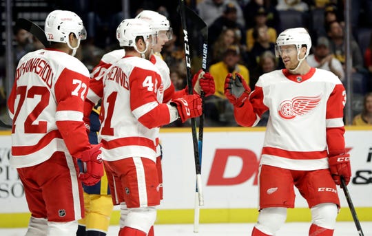 Detroit Red Wings center Luke Glendening (41) celebrates with Nick Jensen (3) and Andreas Athanasiou (72) after Glendening scored a goal against the Nashville Predators during the first period Tuesday, Feb. 12, 2019, in Nashville, Tenn.