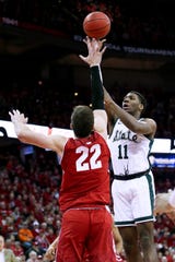 Aaron Henry of the Michigan State Spartans attempts a shot while being guarded by Ethan Happ of the Wisconsin Badgers in the first half.