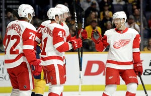 Detroit Red Wings center Luke Glendening (41) celebrates with Nick Jensen (3) and Andreas Athanasiou (72) after Glendening scored a goal against the Nashville Predators during the first period.