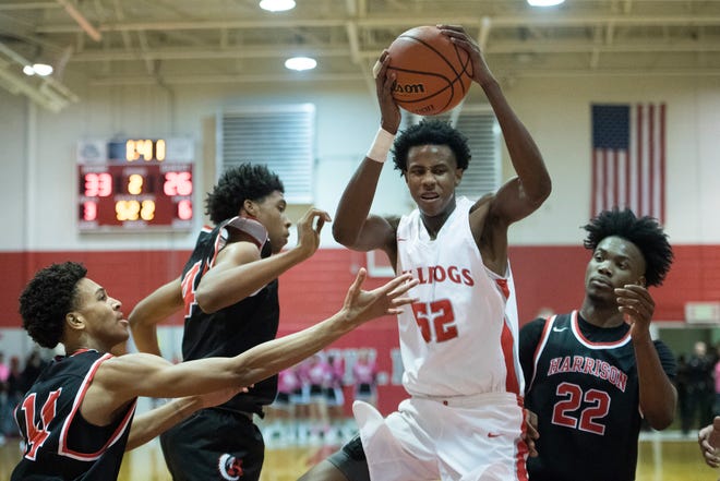Bosse's Kiyron Powell (52) pulls down one of his 14 rebounds in the Bulldogs' 74-56 victory over Harrison Tuesday. He also had 16 points, six blocks and four assists.
