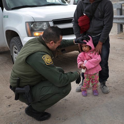 A Border Patrol agent speaks with Central...