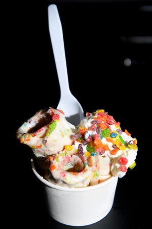 A cup of rolled ice cream topped with Fruity Pebbles at Rolled and Roasted in North Asheville.