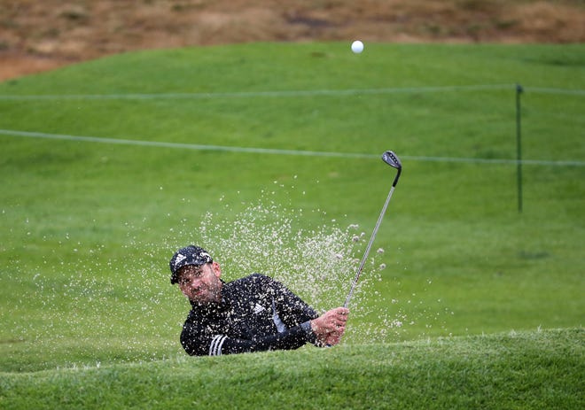 Sergio Garcia, of Spain, hits out of the bunker on the ninth green during the pro-am round of the Genesis Open.