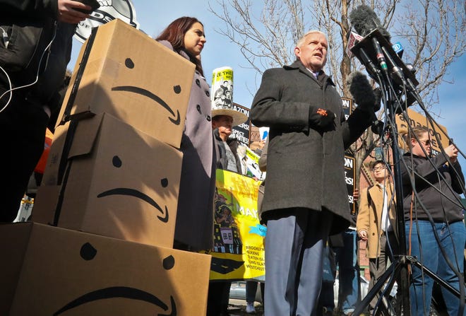 New York City Councilman Jimmy Van Bramer, center, speaks during a conference in Gordon Triangle Park in the Queens borough of New York, following Amazon's announcement it would abandon its proposed headquarters for the area, Thursday Feb. 14, 2019.
