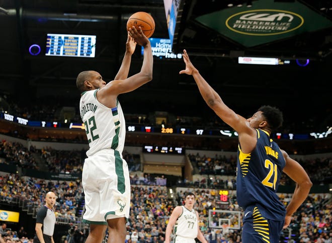 Bucks forward Khris Middleton cans a big three-pointer over Pacers forward Thaddeus Young late in the fourth quarter Wednesday night.