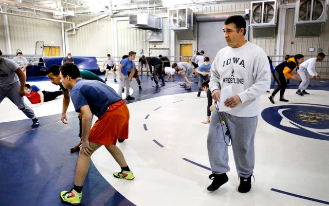 Assistant wrestling coach at Blackman Eric Sacharczyk works with wrestlers during Blackman's practice that is held in the Lane Agri-Park Livestock barn, on Wednesday, Feb. 13, 2019. The Eagleville and Bartlett High School wrestling teams also join in on Blackman's practice.