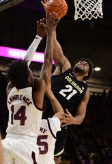 Feb 13, 2019; Boulder, CO, USA; Colorado Buffaloes forward Evan Battey (21) shoots over Arizona State Sun Devils forward Kimani Lawrence (14) and forward Taeshon Cherry (35) in the first half at the CU Events Center. Mandatory Credit: Ron Chenoy-USA TODAY Sports