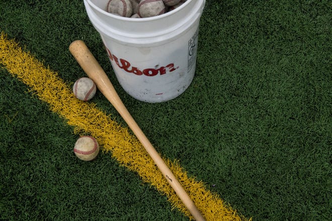 Baseballs and a bat lay on the ground during Augustana baseball practice at the Sanford Fieldhouse in Sioux Falls, S.D., Wednesday, Feb. 13, 2019.