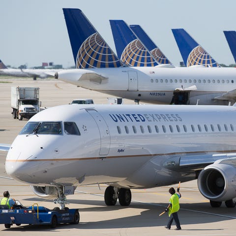 A United Express Embraer E170/75 is pushed back...