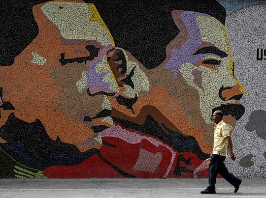 Mosaic depicts late Venezuelan President Hugo Chavez, left, and Venezuelan President Nicolas Maduro in Caracas on Jan. 30, 2019.