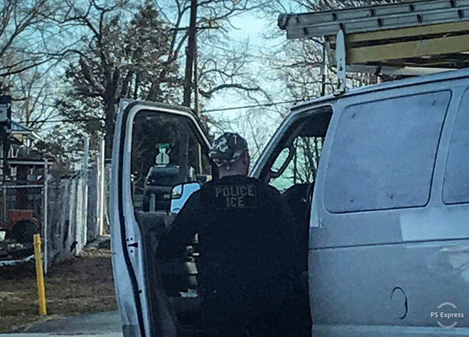 A ICE agent gets into a van he drove to make an arrest in Hendersonville.