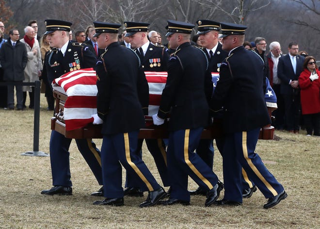 A military honor guard carries the casket of former Rep. John Dingell during a funeral service at Arlington National Cemetery Friday in Arlington, Va.