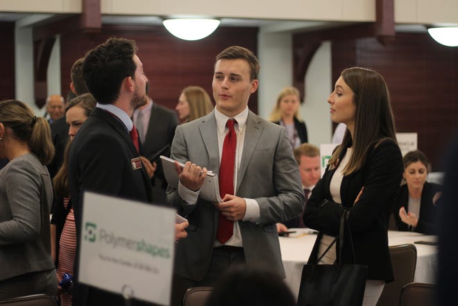 Students in the College of Business talk amongst their groups after the speed-selling competition.