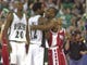 The Spartans Mateen Cleaves hugs Badger Travon Davis after the end play between the University of Wisconsin Badgers and the Michigan State Spartans at the RCA Dome in Indianapolis, Indiana on April 1, 2000. In the background is the Spartans Mike Chappell.