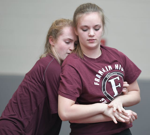 Franklin High School wrestlers Annalise Dodson and Isabella Campbell practice in the school's gym on Feb. 13. "Bella is the technical one, and I'm the crazy one," Annalise said.