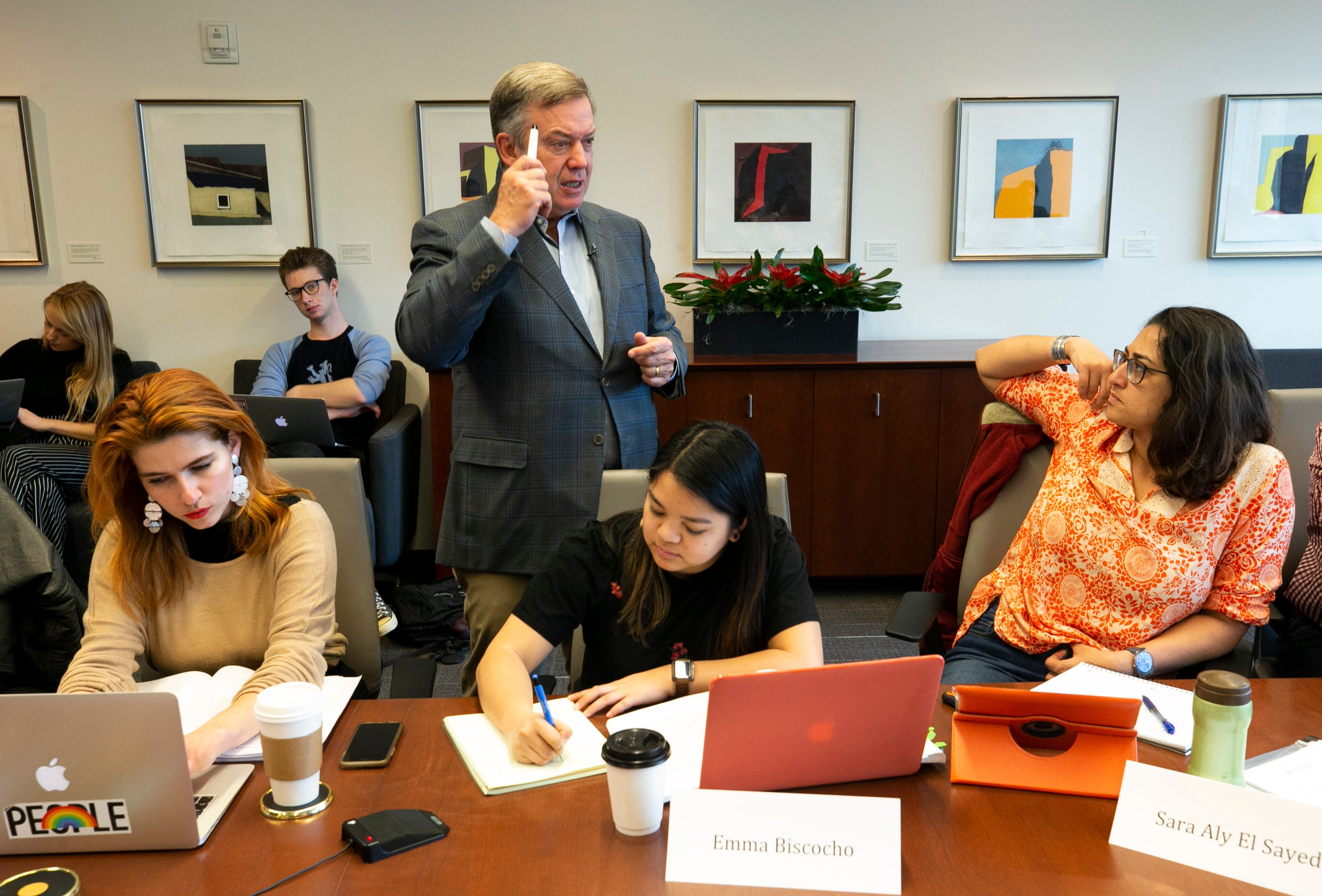 ASU President Michael Crow smiles while teaching the multi-discplinary Science, Technology and Public Affairs class to (from left at front) masters student Sarah Lords, masters student Emma Biscocho and doctoral candidate Sara Aly El Sayed, along with other ASU doctoral, masters and undergraduate students at the Fulton Center at ASU in Tempe on Jan. 30, 2019.