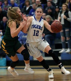 Wrightstown's Meghan Riha dribbles against Freedom's Kenidee Kroening during their North Eastern Conference girls basketball game  Friday in Wrightstown.