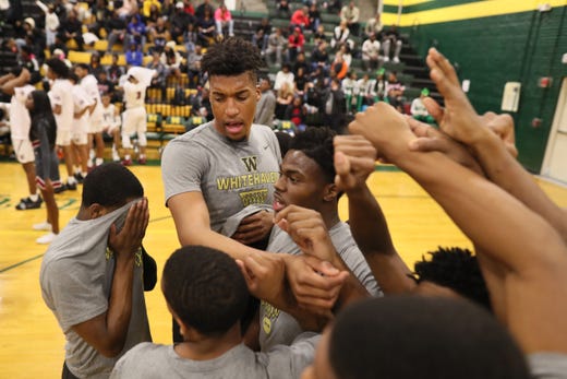 Whitehaven's Jordan Wilmore, who at 7'2" stands more than a foot taller than most of his teammates, in a huddle before their game against East and fellow seven-footer James Wiseman at Memphis Central High School Friday, Feb. 15, 2019.