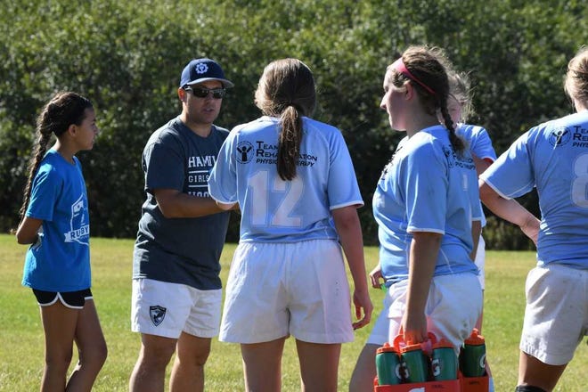 Victor Drover (wearing hat), an assistant head coach for the Hamilton High School girls' rugby team, is going to England to learn about coaching from professional rugby teams thanks to a scholarship he won.