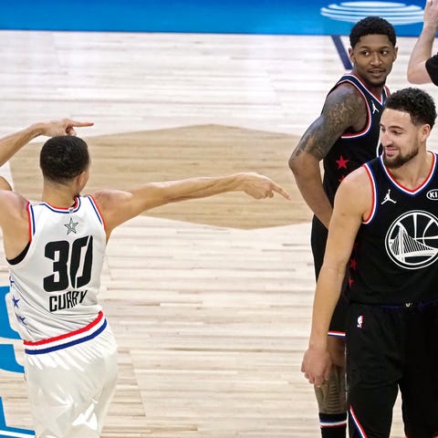 Stephen Curry points at Klay Thompson  after...