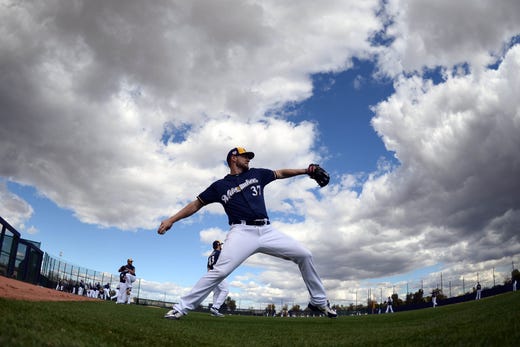 Feb.16: Brewers pitcher Adrian Houser throws during a workout.