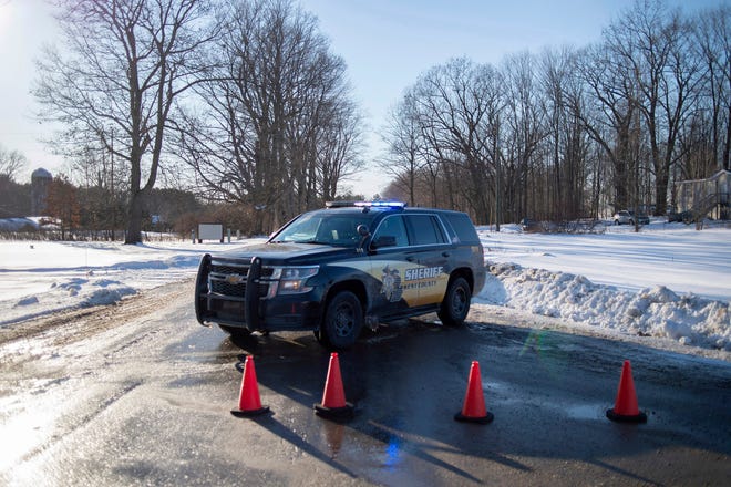 Kent County Sheriff personnel investigate the scene of a fatal shooting near the corner of 19 Mile NE and Division Avenue NE at a property on Monday, Feb. 18, 2019, near Cedar Springs, Mich.