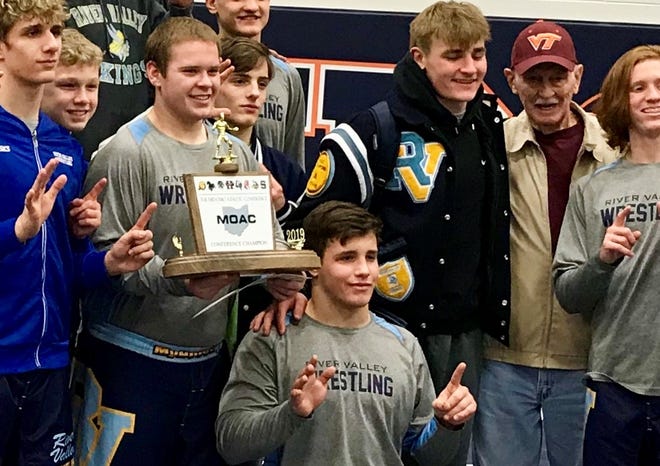 River Valley senior Mitchell Miracle, kneeling, poses with his teammates after the Vikings won their sixth straight MOAC Wrestling Tournament. Miracle returned from ma broken hand recently and won the 195 title at the MOAC meet.