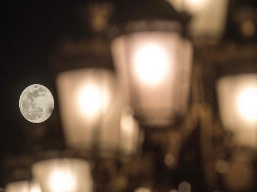 A supermoon rises behind street lights in Skopje, Macedonia on Feb. 19, 2019. 