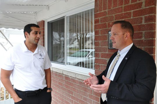 Shady Awad, left, and Taylor Mayor Rick Sollars discuss a partnership to rehabilitate foreclosed homes in the downriver community.