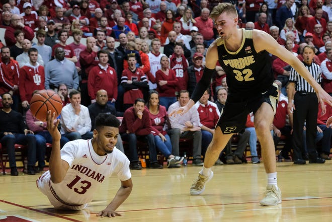 Indiana forward Juwan Morgan (13) loses a ball out of bounds in front of Purdue center Matt Haarms (32) during the second half Tuesday.