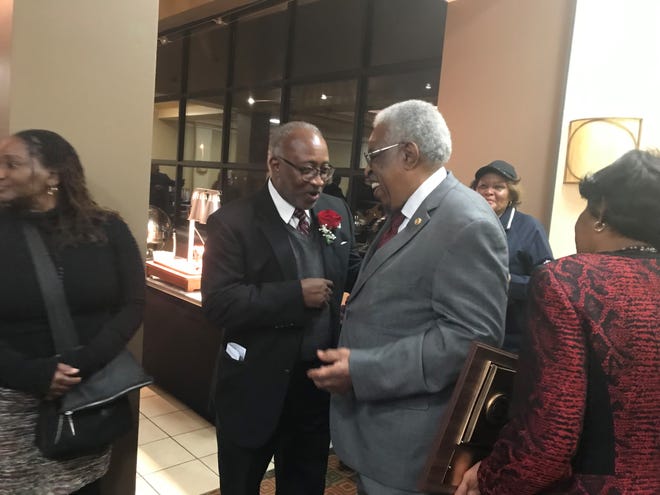 Dr. Melvin Wright (right) is congratulated by a friend after being named the Exchange Club Jackson Man of the Year for 2018 on Monday at the Doubletree Hotel in Jackson.