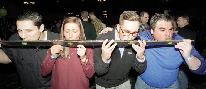 (From left) Sal Fadel, Danielle Snyder, Cole Russell and Tom Stapleton take a shot of tequila from Mi Cosecha Tequila at a previous Oconomowoc Brewfest.