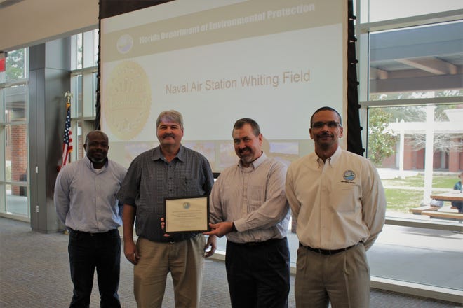 From left, Aaron Mitchell, Whiting Field interim water programs manager; Eddie Wright, Whiting Field water operator; Jeff Kissler, Whiting Field environmental director; and Shawn Hamilton, Florida Department of Environmental Protection Northwest District director, stand for a photo after the 2018 FDEP Plant Operations Award is presented to the installation.