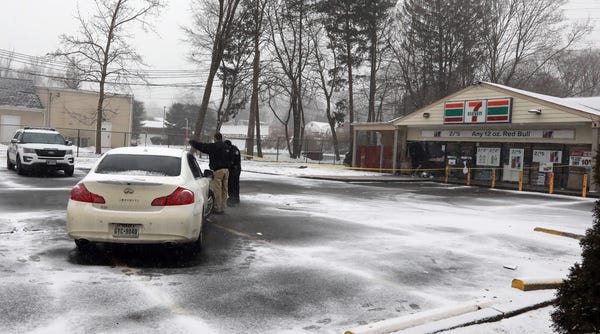 Investigators at the scene where several...