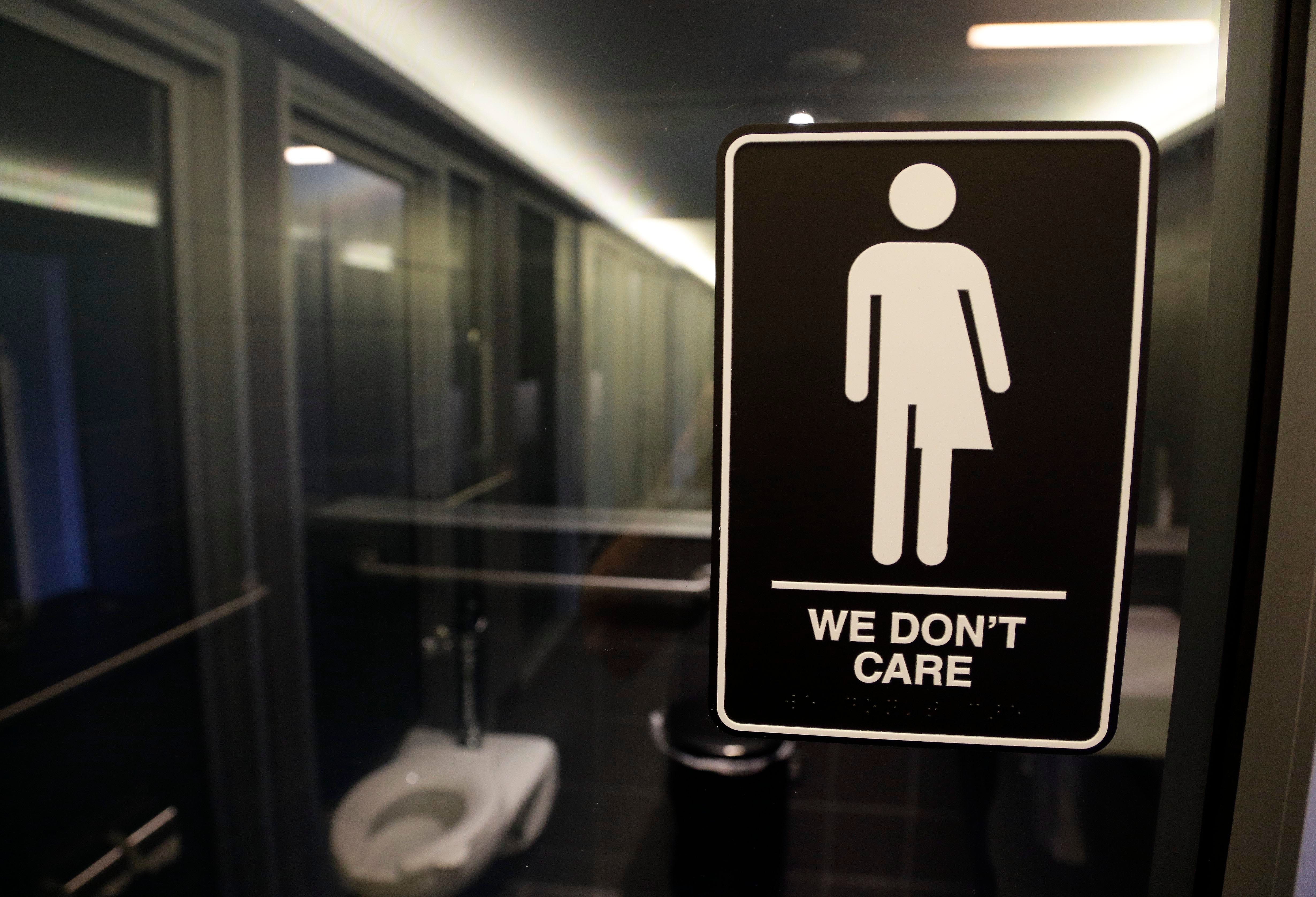 A sign outside a restroom in Durham, North Carolina. A state law requiring people to use the restroom or locker room corresponding with their sex at birth, drew widespread criticism. The law was later repealed.