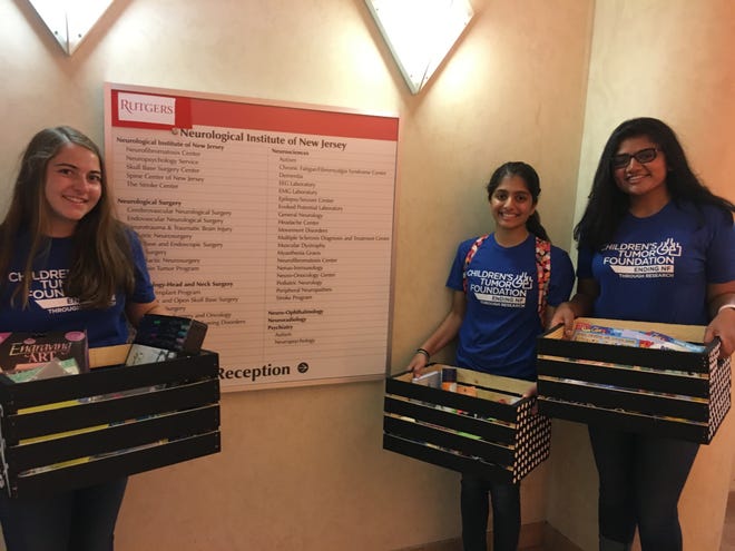 (Left to right) Michelle Masiello of Hillsborough, Mira Amin of Bridgewater and Ritu Peddinti of Bridgewater deliver baskets as part of their community service project at Rutgers New Jersey Medical School at the University Hospital in Newark.
