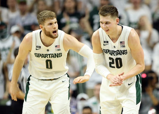 Matt McQuaid, Michigan State Guard, and forward Kyle Ahrens react in the second half of the 71-60 win over Rutgers on Wednesday, Feb. 20, 2019, at the Breslin Center.