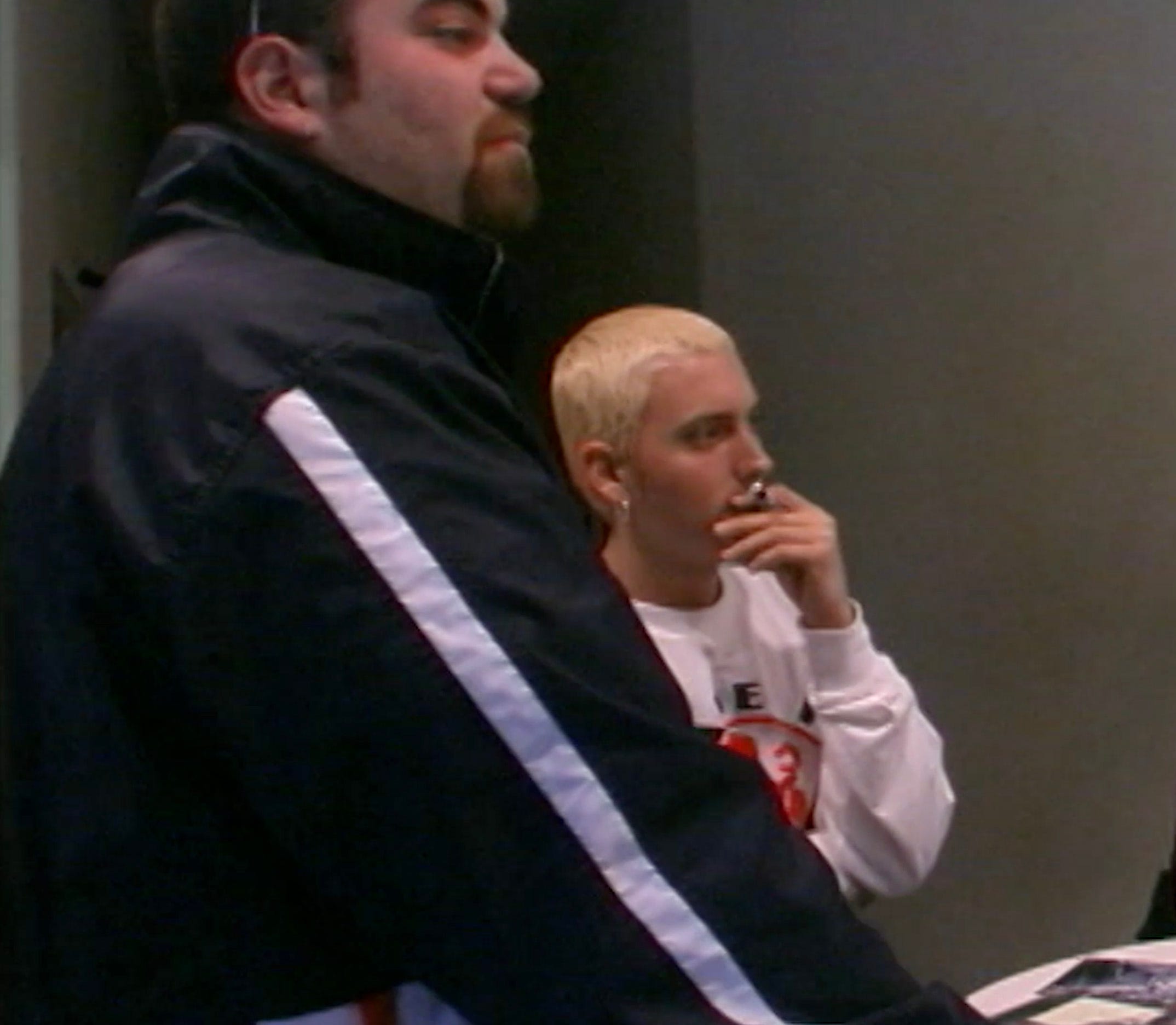 Paul Rosenberg, Eminem's manager, left,  watches with Eminem a broadcast of "MTV Spring Break" in a kitchenette at the Mix Room in Burbank, Calif., in March 1999.