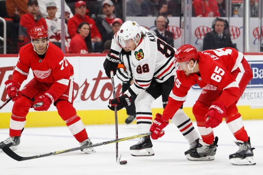Chicago Blackhawks right winger Patrick Kane (88) will play defenseman Danny DeKeyser (65) of the Detroit Red Wings and center Andreas Athanasiou (72) in the first period at the Little Caesars Arena on the 20th. February 2019.
