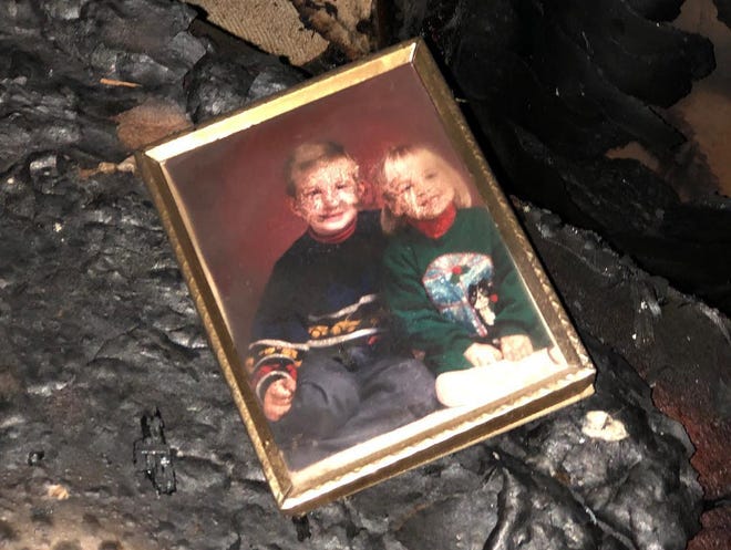 A photo damaged from smoke is one of the few remaining recognizable items from the home of Sally Clark, Rod and Greg Wozniak, which was ravaged by a recent fire.
