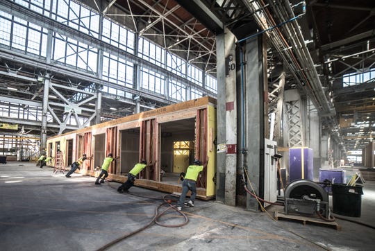 Workers assemble a dwelling built by FactoryOS, a new San Francisco-area company that does the bulk of its housing construction off-site (OS), which CEO Rick Holliday says leads to a 30 percent reduction in price over on-site building.
